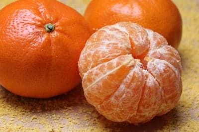 Close-up of peeled and whole tangerines