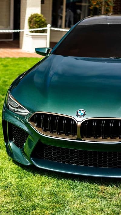 Green BMW M8 Gran Coupe on Lush Green Lawn