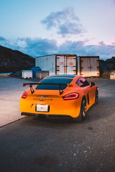 Vibrant Orange Porsche Cayman GT4 Dusk Mobile Wallpaper