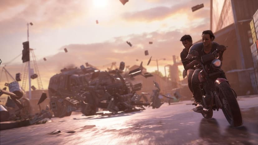 Nathan Drake and Sully ride a motorcycle through fire and debris during a sunset chase in a tropical city.