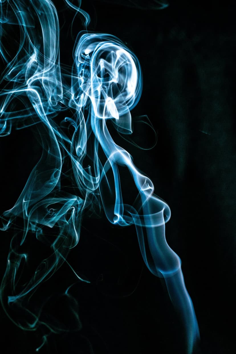 Blue wisps of smoke swirl in intricate patterns against a solid black background for a high-contrast look.
