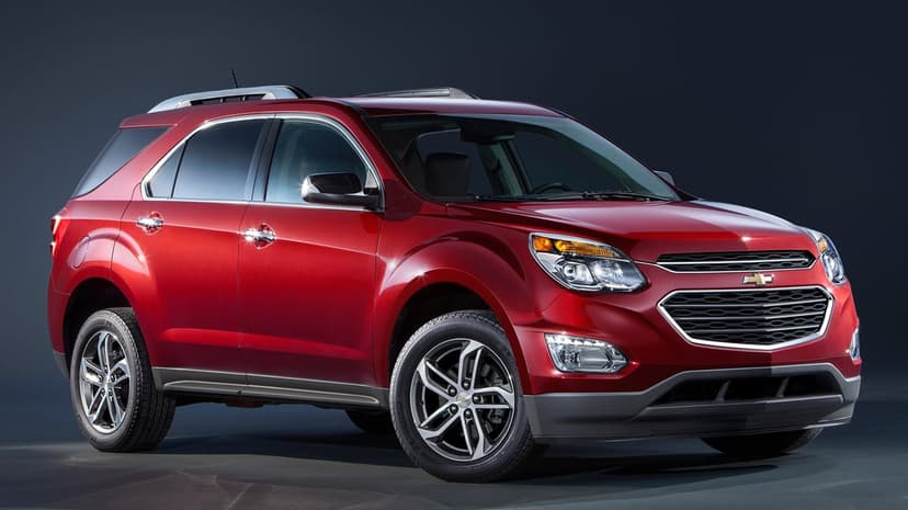 Red Chevrolet Equinox SUV showcased in a dark studio environment with chrome details and sleek lighting.