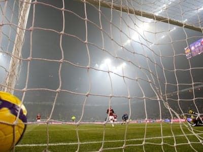 Goal Net View: Football Match with Ball and Players