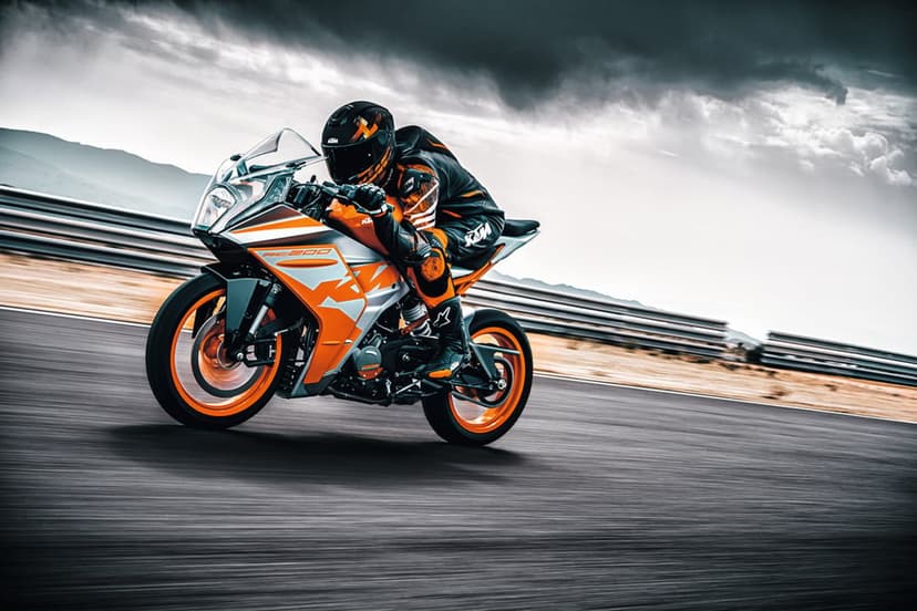 KTM RC 200 sportbike leaning on a racetrack with a rider in orange gear under a stormy, cloudy sky.