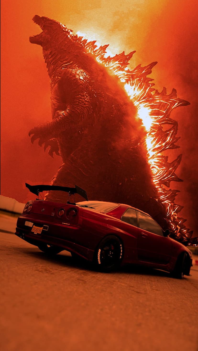 Godzilla roars with glowing dorsal fins above a red sports car amidst a smoky orange and crimson haze.