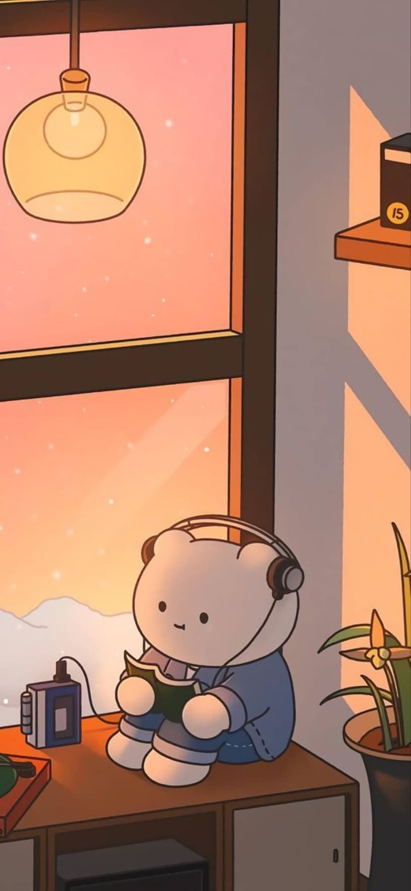 Brown bear wearing headphones sits at a desk reading a book by a snowy window during a golden sunset.