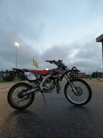 Yamaha dirt bike parked under cloudy sky