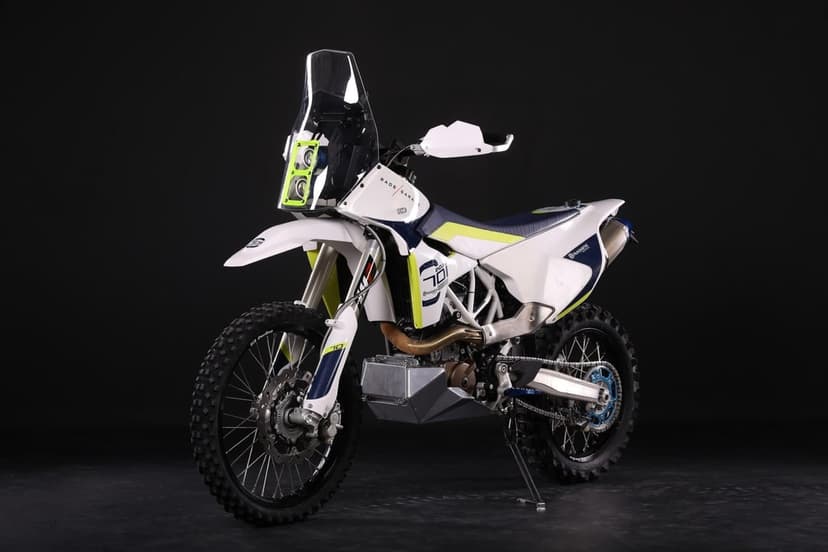 Husqvarna 701 Enduro rally motorcycle with white fairings and neon accents against a black background.