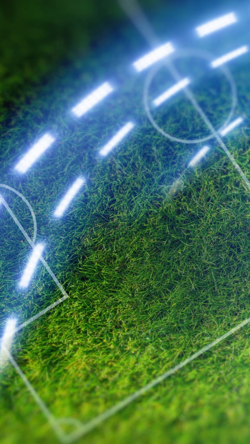 Glowing blue neon boundaries and circles outline a bright green synthetic soccer pitch from an overhead view.