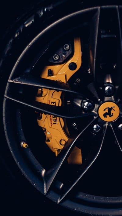 Ferrari Rim Detail with Yellow Caliper Phone Background