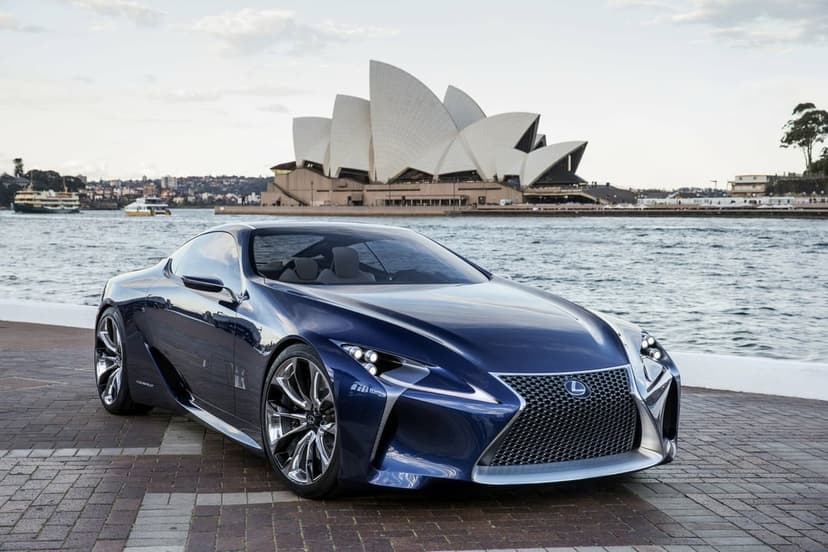 Blue Lexus concept car on a paved waterfront with the white sails of the Sydney Opera House in the background.