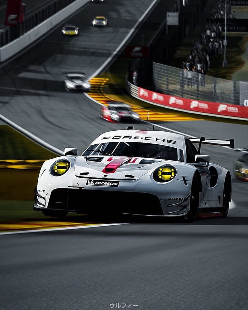 Porsche 911 RSR race car with yellow headlights speeds on a sunny track with visible motion blur effects.