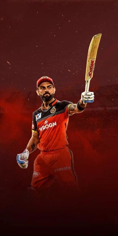 Virat Kohli celebrates victory with MRF bat and RCB jersey