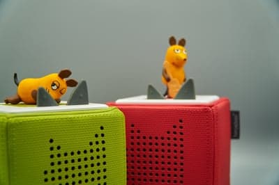 Two Toniebox story cubes with toy figures