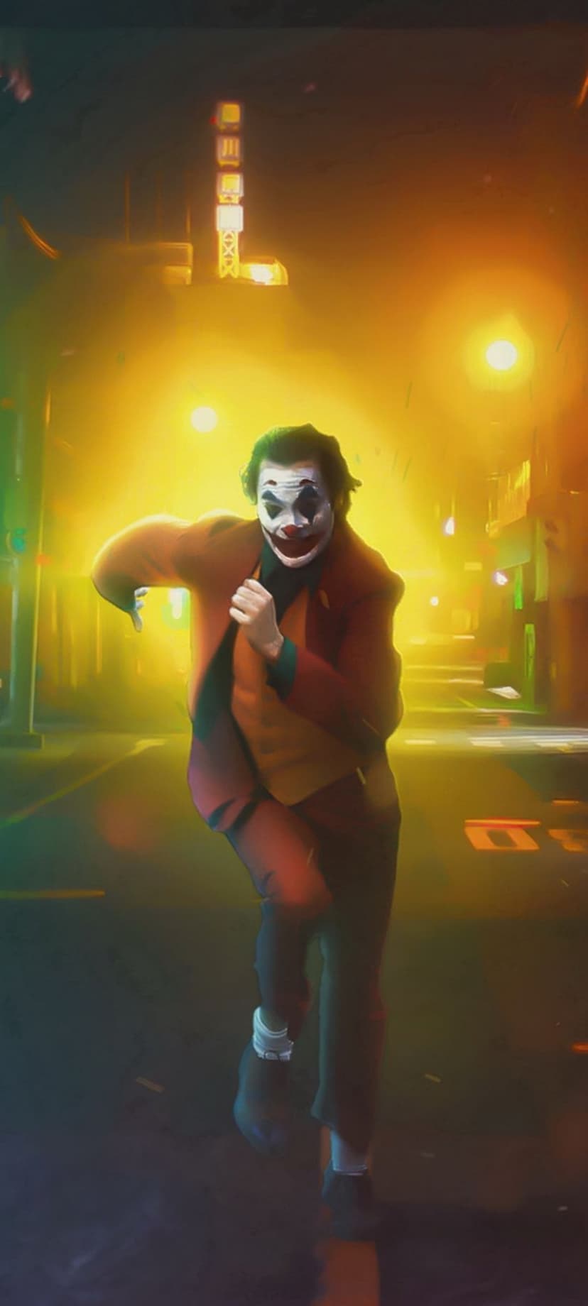 Joker in a red suit runs through a dark city street under hazy neon lights and flickering streetlamps.