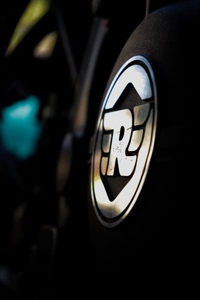 Close-up of Royal Enfield 'RE' logo on a motorcycle