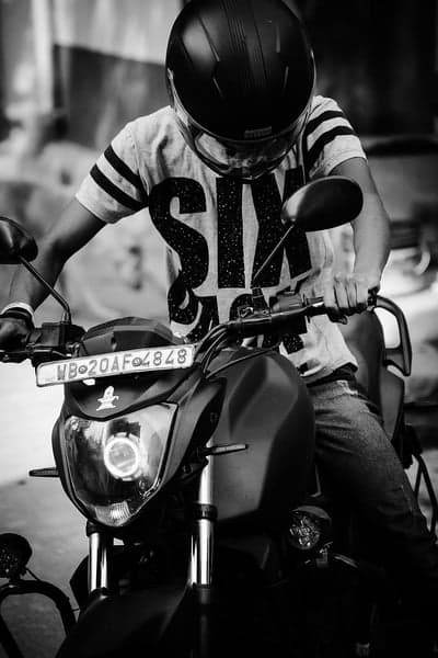 Man in Helmet on Motorcycle with "SIX" Shirt