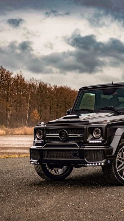 Black Brabus G-Wagon parked by a lake
