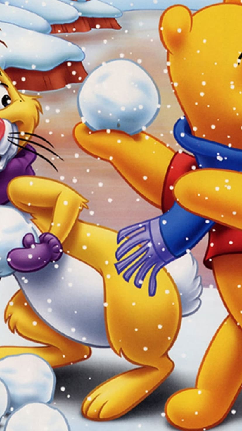 Winnie the Pooh holds a snowball beside Rabbit while soft snowflakes fall in a whimsical winter landscape.