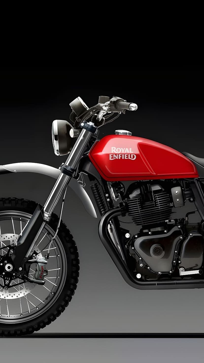 Royal Enfield motorcycle engine and front knobby tire with chrome details and a red fuel tank in a close-up view.