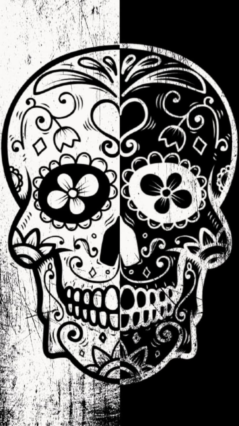 Ornate sugar skull split vertically with inverse black and white floral patterns and a distressed texture.