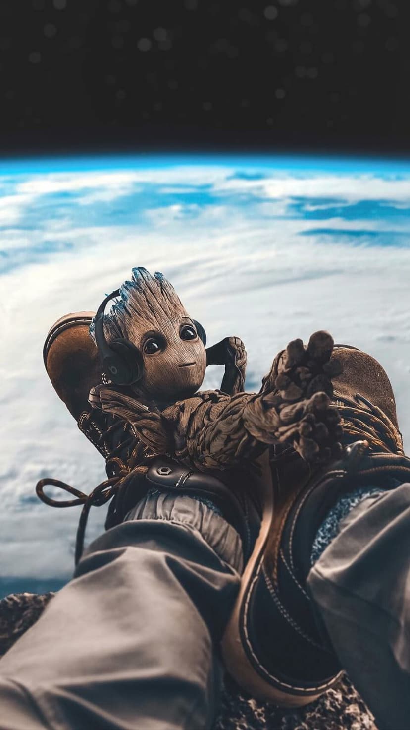 Baby Groot wearing a white spacesuit and headphones relaxes against a backdrop of Earth's blue horizon and stars.
