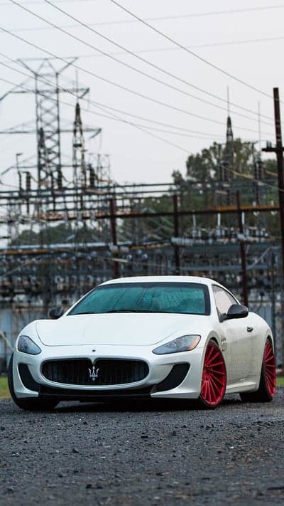 White Maserati GranTurismo with red wheels