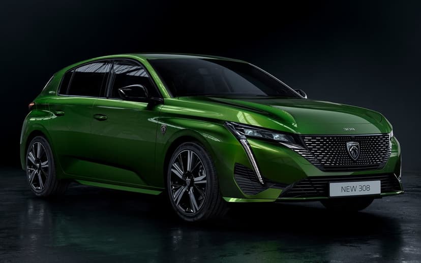 Front three-quarter view of a metallic green Peugeot 308 hatchback in a dark, moody studio environment.
