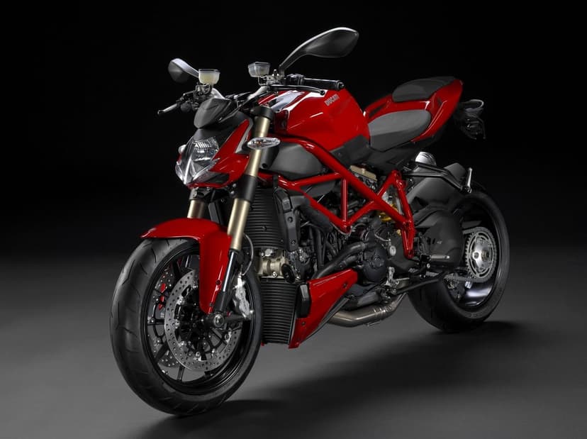 Red Ducati Streetfighter motorcycle with gold forks and trellis frame on a black studio background.