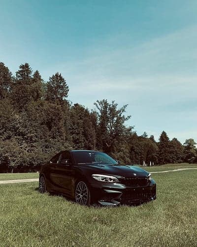 BMW M2 Performance Car in Green Field Mobile Background