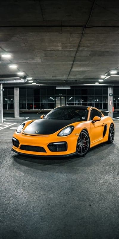 Orange Porsche Cayman GT4 in Parking Garage
