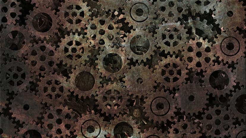 Interlocking rusty iron gears show heavy orange oxidation and worn metallic textures in a dense macro view.