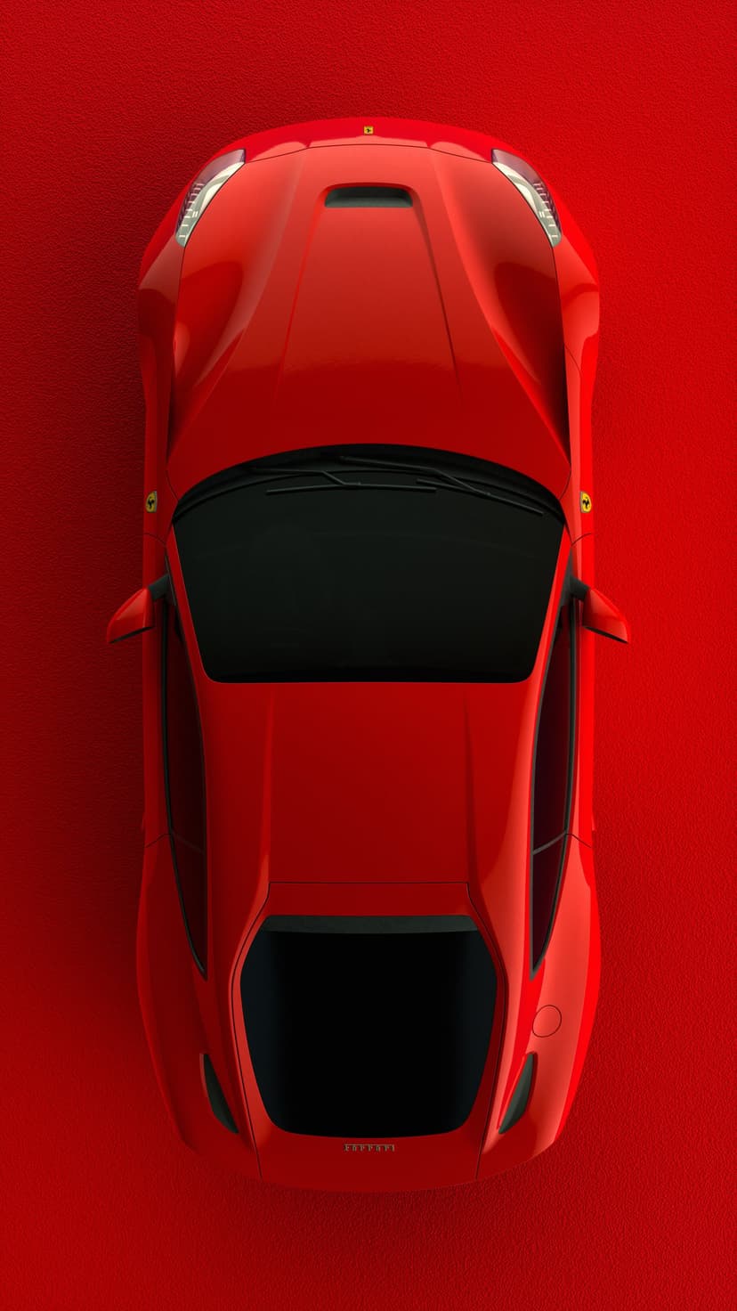 Red Ferrari sports car viewed from above against a textured crimson surface featuring a dark black windshield.