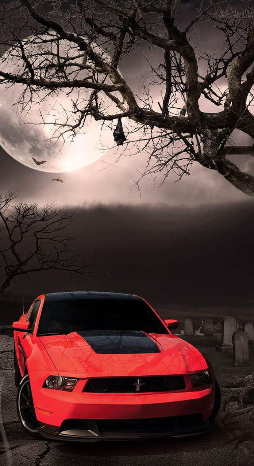 Red Ford Mustang among gravestones under a glowing full moon with gnarled trees and silhouettes of bats.