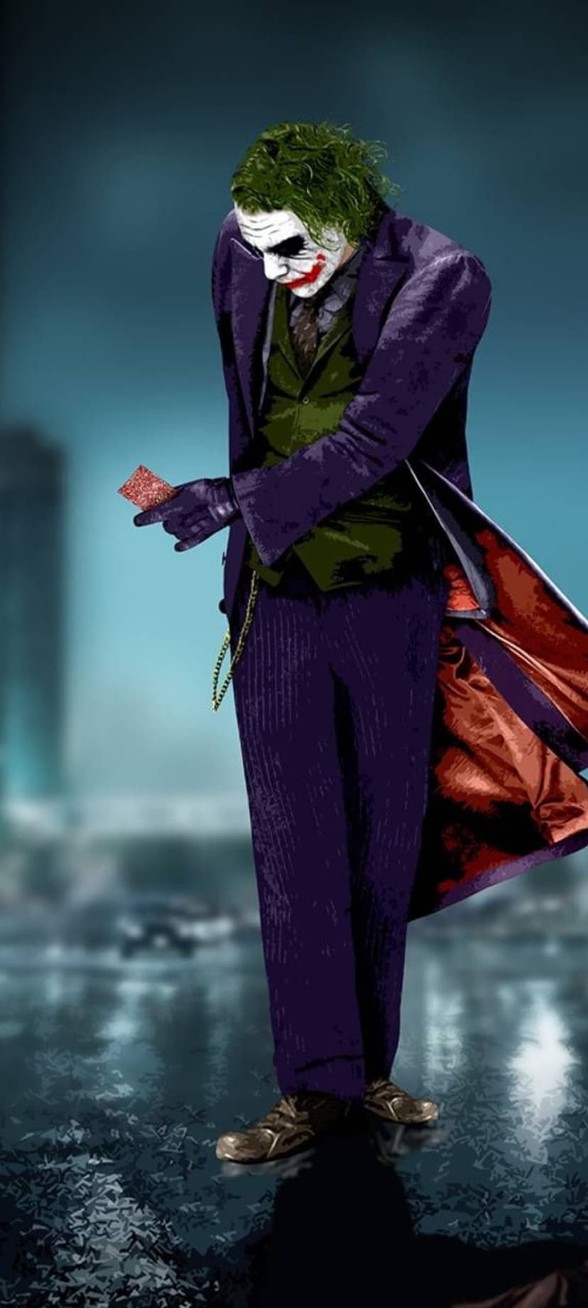 Joker in a purple suit holds a playing card on a wet city street at night with blurred background lights.