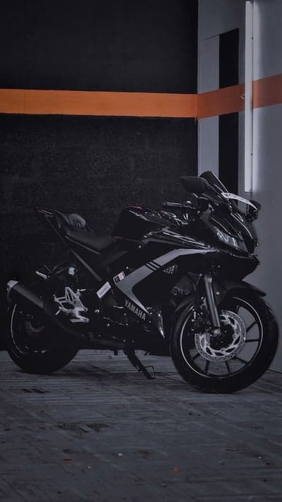 Sleek Black Yamaha R15 Motorcycle in Modern Setting