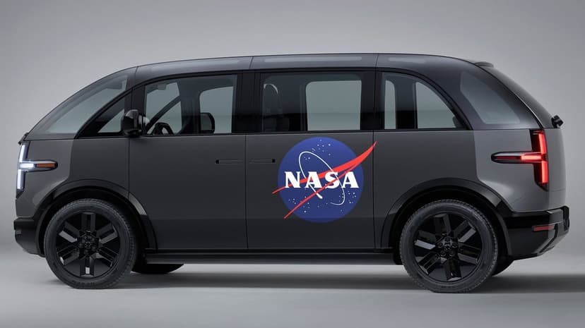 Profile of a matte grey NASA electric transport van with black wheels and a blue logo on a clean grey background.