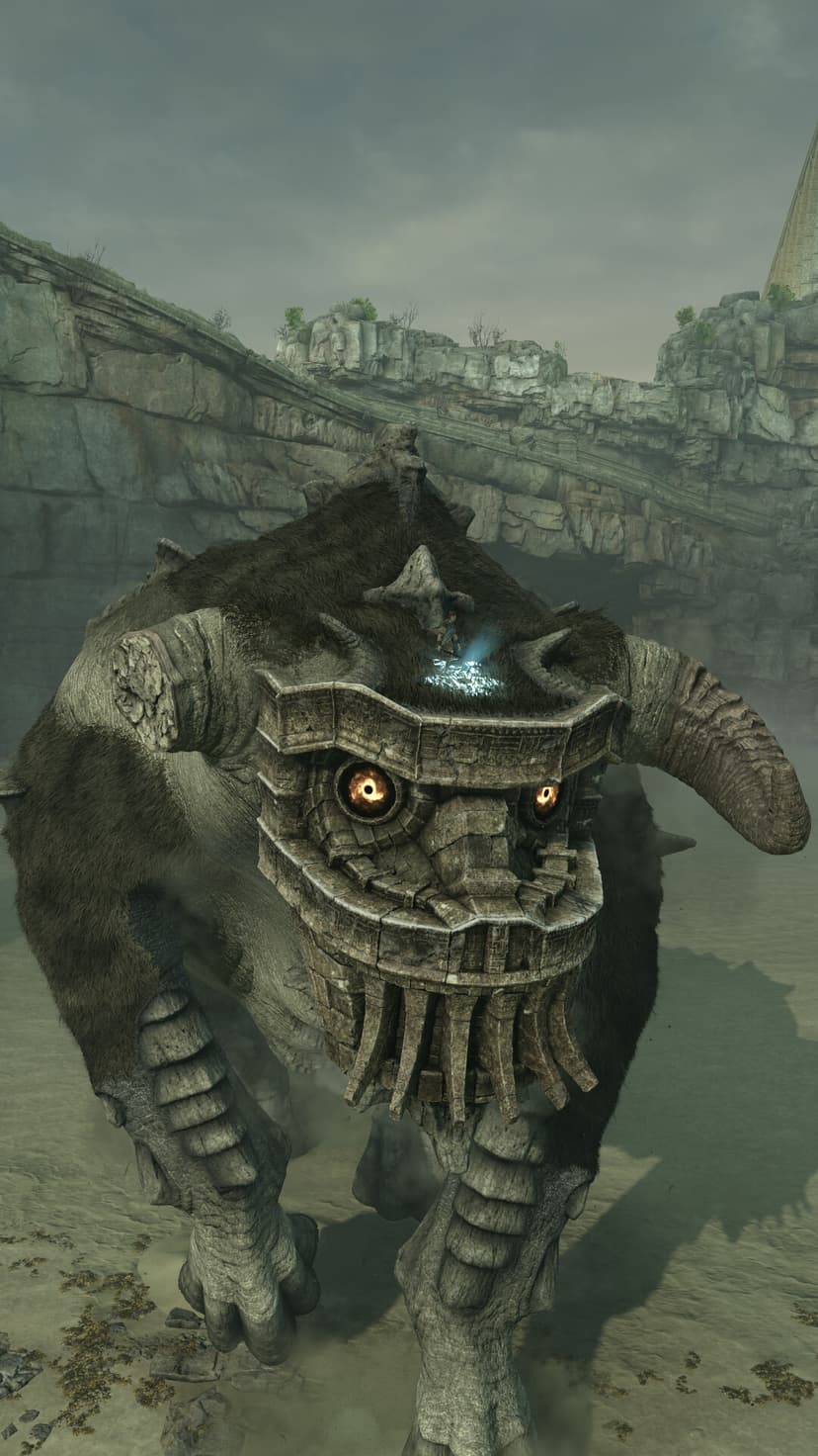 Giant stone colossus with glowing amber eyes and a blue sigil on its head in a misty canyon.