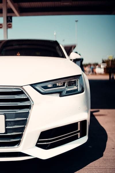 White Audi A4 Sedan Headlight and Grille Close-up