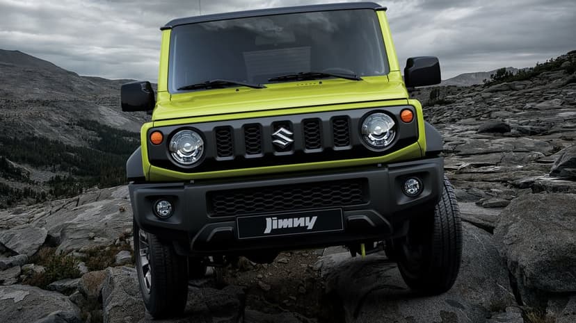 Suzuki Jimny SUV in lime green climbing grey jagged rocks in a mountainous terrain under a moody cloudy sky.