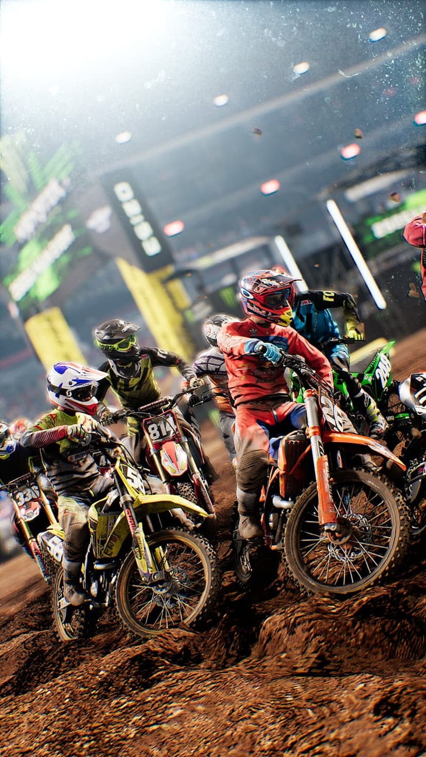 Motocross racers leaning into a dirt track turn while mud sprays from the rear tires of their motorcycles.