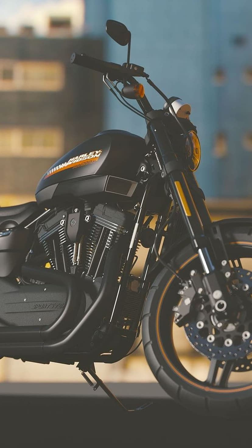 Harley Davidson V-twin engine and chrome front wheel positioned against a blurred urban building background.