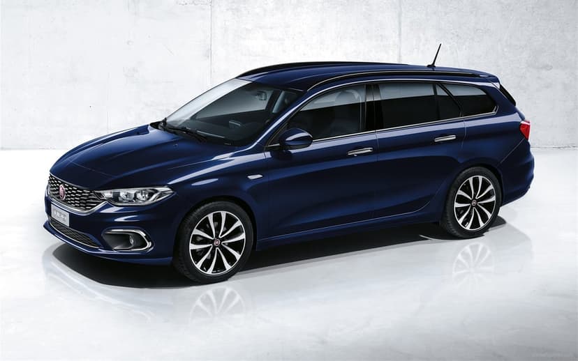 Dark blue Fiat Tipo station wagon parked in a minimalist studio against a gray wall with floor reflections.