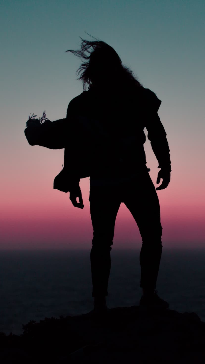 Masked figure in a dark hoodie stands before a glowing neon cityscape with vibrant blue and pink lighting.
