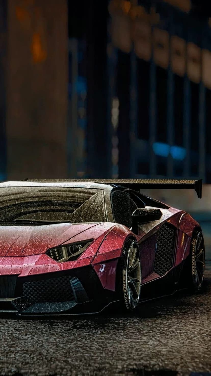 Red Lamborghini Aventador with a large rear wing parked on wet asphalt during a dark, rainy night in the city.
