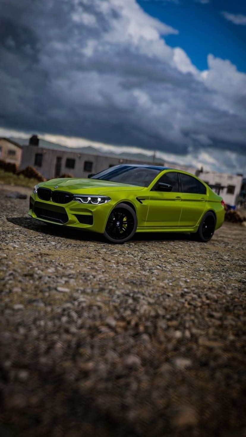 Lime green BMW M5 sedan on a gravel path with weathered buildings and dark, stormy clouds in the background.