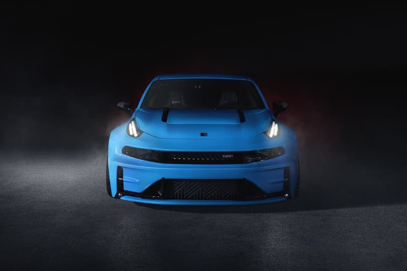 Cyan blue performance car with glowing LED headlights centered in a dark, smoky studio on asphalt.