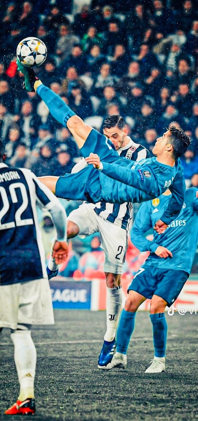 Cristiano Ronaldo performs a mid-air bicycle kick in a white kit against a blurry stadium backdrop for mobile.
