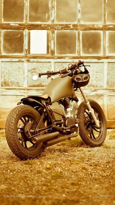 Vintage Motorcycle with Goggles and Rustic Garage Background