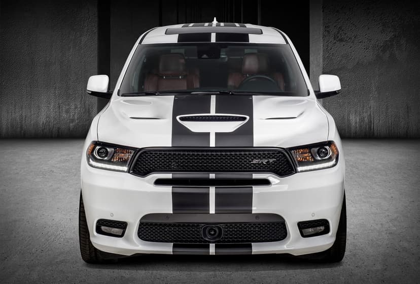 White Dodge Durango SRT front view with black racing stripes, LED headlights, and red leather interior seats.